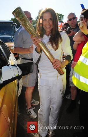 Melanie Chisholm carries the Olympic flame through Liverpool Liverpool, England - 01.06.12