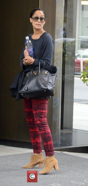 Actress Tracee Ellis Ross and Akon's little brother Bu Thiam  exit their SoHo Hotel and share a goodbye kiss....