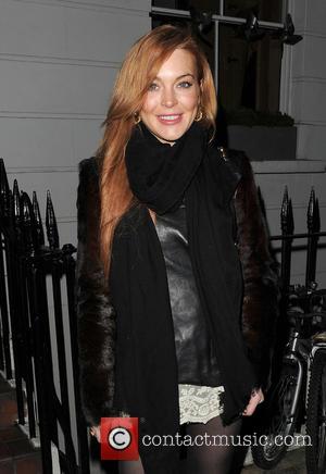 Lindsay Lohan - Lindsay Lohan and a male companion leave...