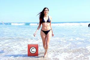 Blanca Blanco - John Savage and his young actress girlfriend Blanca Blanco frolicking in the surf on Malibu Beach -...