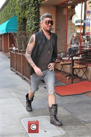 Adam Lambert - Singer Adam Lambert looks fashionable in knee length denim shorts, boots and sleeveless black leather waist jacket...