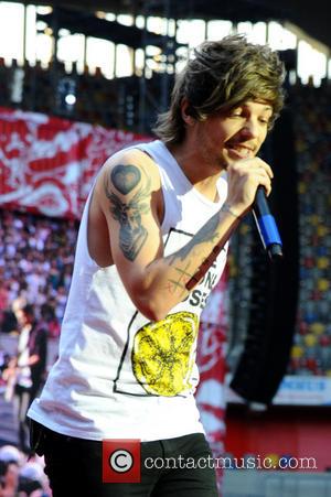 One Direction and Louis William Tomlinson - One Direction performing live in concert during their 'Where We Are' tour at...