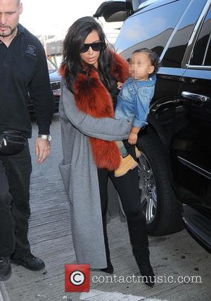 Kim Kardashian and North West - Kim Kardashian and North West arrive at LAX - Los Angeles, California, United States...