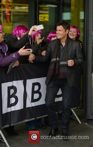 Donny Osmond - Donny Osmond leaves the BBC Breakfast studios at MediaCityUK. A small group of fans wear purple wigs...