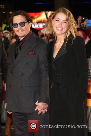 Johnny Depp, Amber Heard, Johnny Depp and Amber Heard - The UK premiere of 'Mortdecai' held at the Empire cinema...