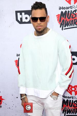 Chris Brown Claims Images Of Him With Hands Around Woman's Neck Was Just "Playful"