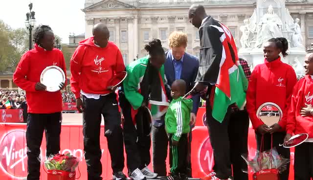 Prince Harry Poses With Marathon Winners Outside Buckingham Palace